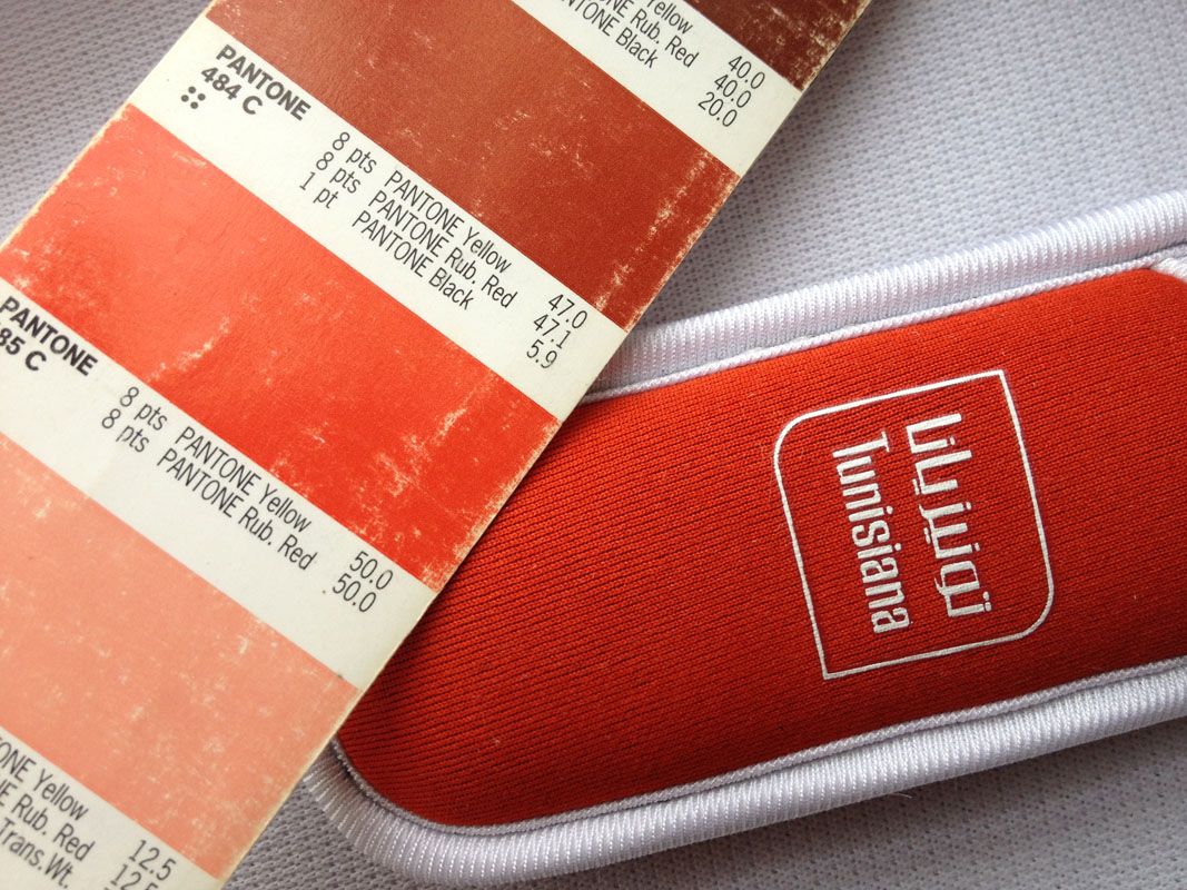 Pantone colour swatches next to a red printed sleeve